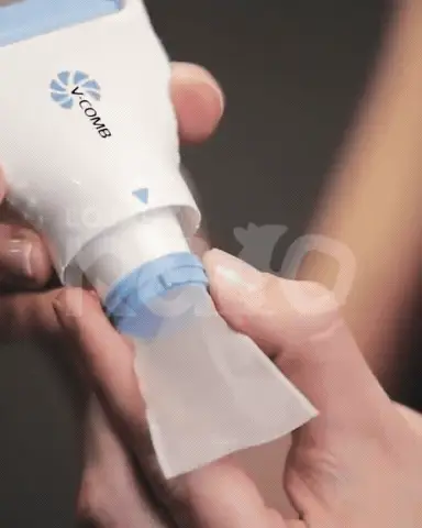 Hands removing the mesh collection filter from the device